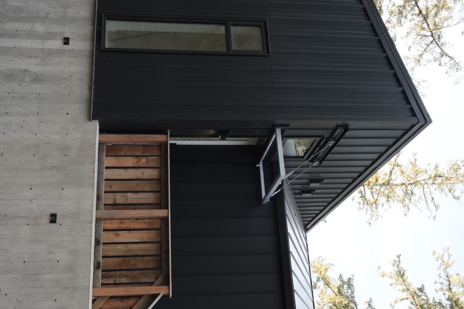 Board and batten cladding meeting concrete and timber