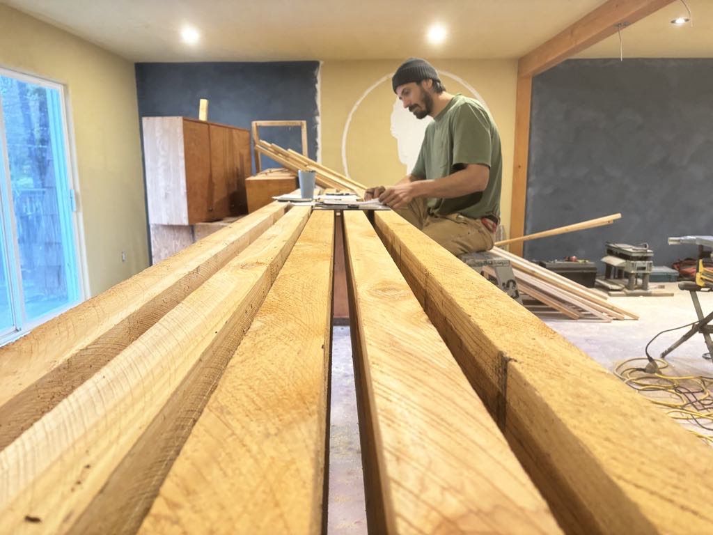 Quinn Yates laying out timber on an interior job site